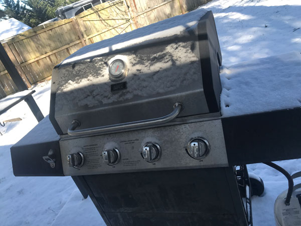 snow covered BBQ grill